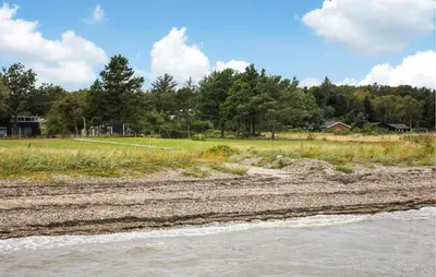 a view of a river with a field and trees at 3 Bedroom Beautiful Home In Thyholm in Thyholm