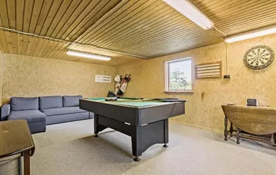 a living room with a pool table and a couch at 3 Bedroom Stunning Home In Farsø in Farsø