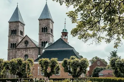 a large building with two towers on top of it at Rækkehus tæt på skov, sø og by in Viborg