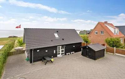 a black building with a patio and a house at Lovely Home In Fur With Sauna in Fur