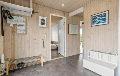 a room with wooden walls and a hallway with a door at Lovely Home In Fur With Sauna in Fur