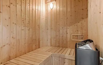 a wooden sauna with a trash can in it at Lovely Home In Fur With Sauna in Fur