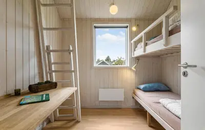 a small room with bunk beds and a window at Beautiful Home In Farsø With Wifi in Farsø
