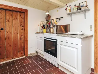 a kitchen with white appliances and a brown tile floor at Panoramic View Fisherman's House - By Traum Ferienwohnungen in Vesløs