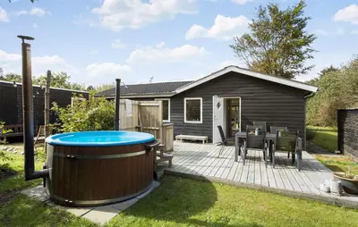 a backyard with a hot tub and a house at Pet Friendly Home In Spøttrup With Wifi in Spottrup