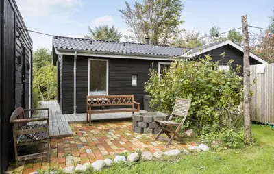 a backyard with a bench and a house at Pet Friendly Home In Spøttrup With Wifi in Spottrup