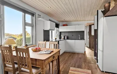 a kitchen and dining room with a table and chairs at 2 Bedroom Lovely Home In Thisted in Thisted