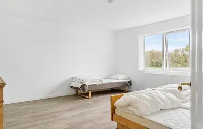 a white room with two beds and a window at 4 Bedroom Nice Home In Harboøre in Harboør