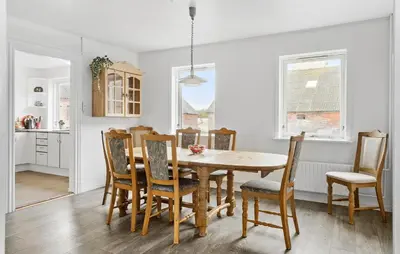 a kitchen and dining room with a wooden table and chairs at 4 Bedroom Nice Home In Harboøre in Harboør