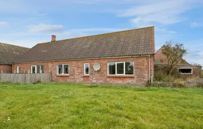 a brick house on a grassy field in front at 4 Bedroom Nice Home In Harboøre in Harboør