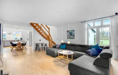a living room with a couch and a table at Det gamle forsamlinghus in Struer