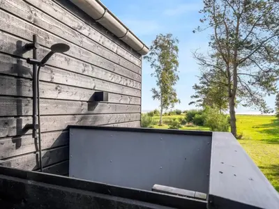 a bench sitting on the side of a building at Holiday Home Jahn - 250m to the fjord by Interhome in Højslev