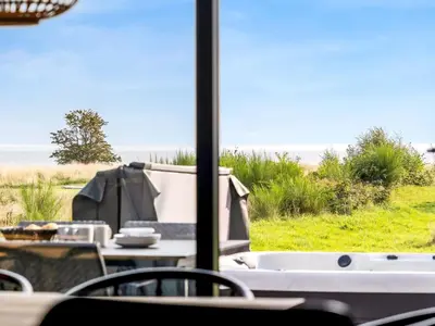 a table and chairs with a view of the ocean at Holiday Home Jahn - 250m to the fjord by Interhome in Højslev
