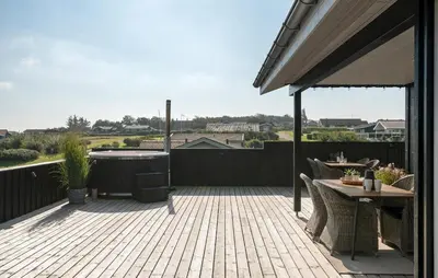 a patio with a table and a hot tub at Cozy Home In Lemvig With Wifi in Lemvig