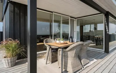 a patio with a table and chairs on a deck at Cozy Home In Lemvig With Wifi in Lemvig