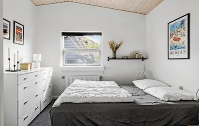 a bedroom with a bed and a dresser and a window at Lovely Home In Blokhus With Wifi in Blokhus