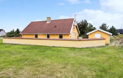 a yellow house with a brown roof on a field at Pet Friendly Home In Thisted With Sauna in Thisted