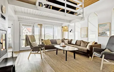 a living room with a couch and a table at Awesome Home In Thisted With Sauna in Thisted