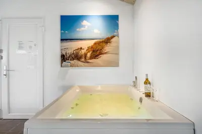a bath tub with a picture of a beach at Pool And Activity House With A 180-Degree View Of The North Sea, Located At Lild Strand in Frøstrup