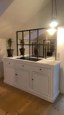 a large white cabinet in a room with potted plants at En SMUK og CHARMERENDE OASE meget tæt på centrum! in Holstebro