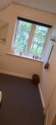 a room with a large window in a house at Dybvad Mølle bed and breakfast in Års