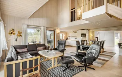 a living room with a couch and a table at Gorgeous Home In Blokhus With Sauna in Blokhus