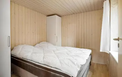 a white bed in a room with a window at Gorgeous Home In Blokhus With Sauna in Blokhus