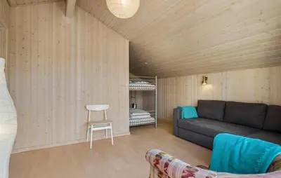 a living room with a couch and a bed at Pet Friendly Home In Blokhus With Wifi in Blokhus