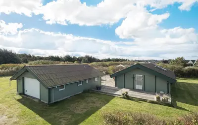 a home with a green and white house at Pet Friendly Home In Blokhus With Wifi in Blokhus