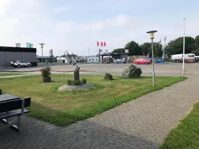 a park with a statue in the middle of a parking lot at Struer Festcenter - Vest Bowl lejlighed 1 Bredgade 62 C in Struer