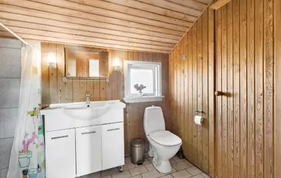 a bathroom with a white toilet and a sink at Pet Friendly Home In Thisted With Sauna in Thisted