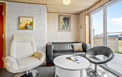 a living room with a couch and chair and a table at Beautiful Home In Thisted in Thisted