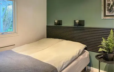 a bedroom with a bed with two lights on the wall at Awesome Home In Hjerm With Wifi in Hjerm
