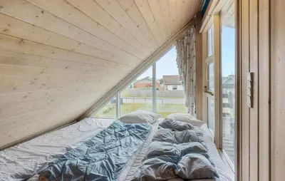 a bed in a room with a large window at Beautiful Home In Thisted With Sauna in Thisted