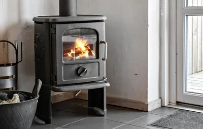 a stove in a room with a fire in it at 2 Bedroom Cozy Home In Thisted in Thisted