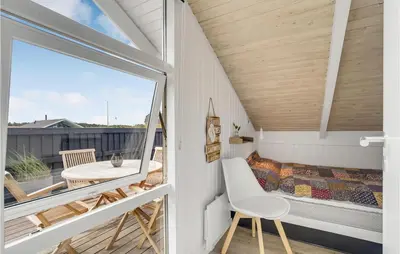 a room with a balcony with a bed and a window at Three-Bedroom Holiday Home Harboøre With A Fireplace 06 in Harboør