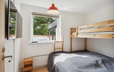 a bedroom with a bed and a window at Three-Bedroom Holiday Home Thyholm With A Fireplace 06 in Thyholm