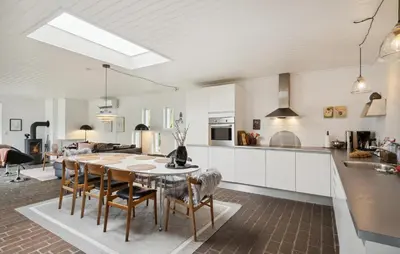 a kitchen and dining room with a table and chairs at Three-Bedroom Holiday Home Thyholm With A Fireplace 06 in Thyholm