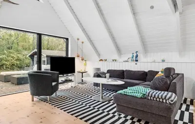 a living room with a couch and a table at 3 Bedroom Lovely Home In Spøttrup in Spottrup