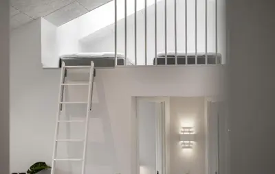 a white bunk bed in a room with a ladder at Cozy Home In Saltum With Sauna in Saltum