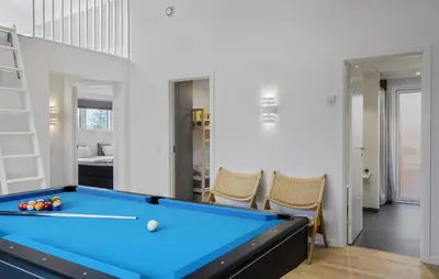 a pool table in a room with a bedroom at Cozy Home In Saltum With Sauna in Saltum