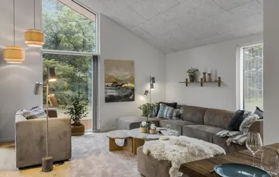 a living room with a couch and a table at Cozy Home In Saltum With Sauna in Saltum