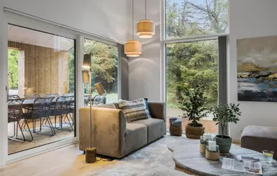a living room with a couch and a table at Cozy Home In Saltum With Sauna in Saltum