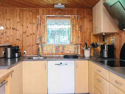 a kitchen with a sink and a window at Panoramic Fjord Retreat with Spa Bath in Øster Assels