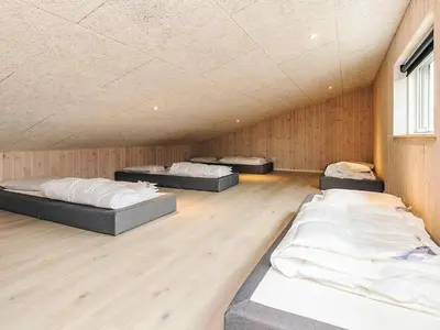 three beds in a room with a wooden floor at 5 star holiday home in Højslev in Højslev