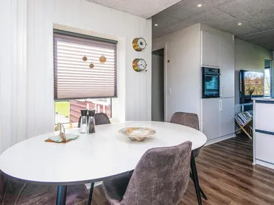 a kitchen with a white table and chairs in a room at 4 person holiday home in Lemvig in Lemvig