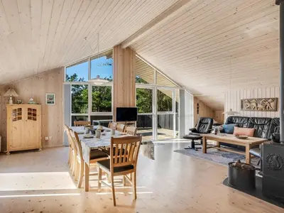a large living room with a table and chairs at Holiday Home Skrollan - 200m to the fjord by Interhome in Sindrup