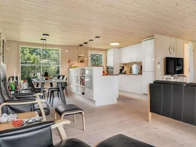 a kitchen and dining room with a table and chairs at Holiday Home Rajna - 500m to the fjord by Interhome in Vestervig