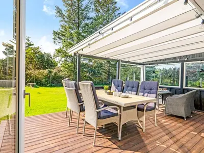 a patio with a table and chairs on a deck at Holiday Home Rajna - 500m to the fjord by Interhome in Vestervig