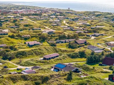 an aerial view of a village on a hill next to the ocean at Holiday Home Naema - 400m from the sea by Interhome in Blokhus